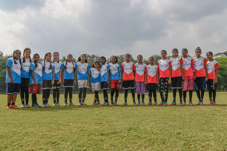 Girl students from our play program posing together before playing a competitive match