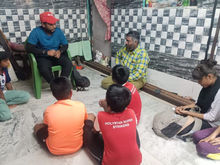 One of our Coach Akbar interacting with a parent in a low-income community in Mumbai