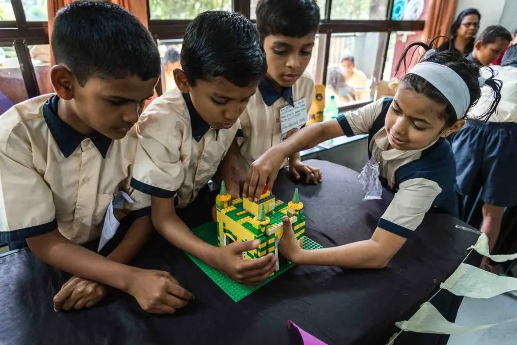 Children participating in hands-on building activities in EL-Build program